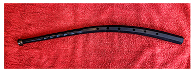 Musical instrument with a trumpet-like mouthpiece and a short, black, curved body with finger-holes